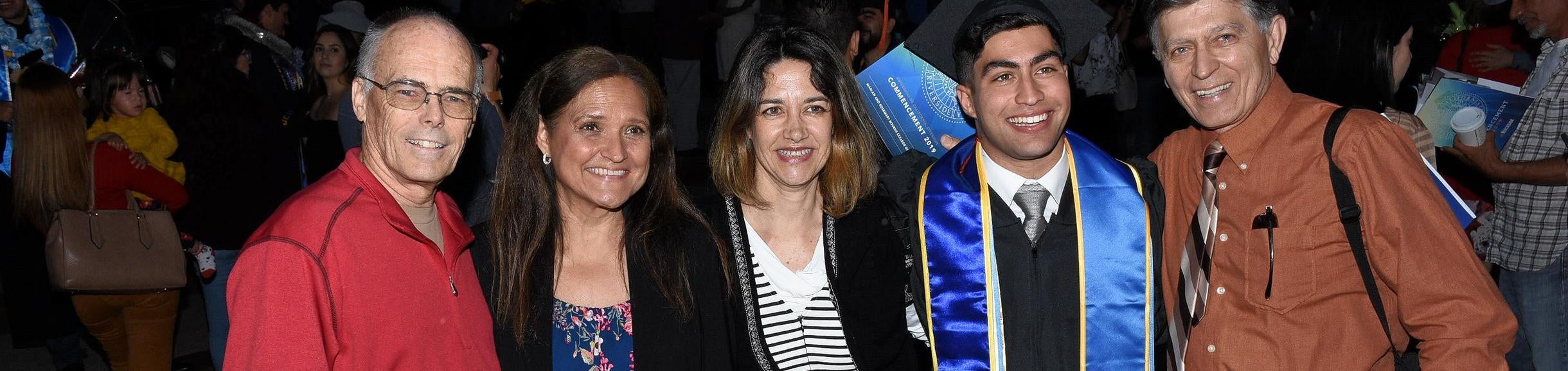 family posed around engineering graduate